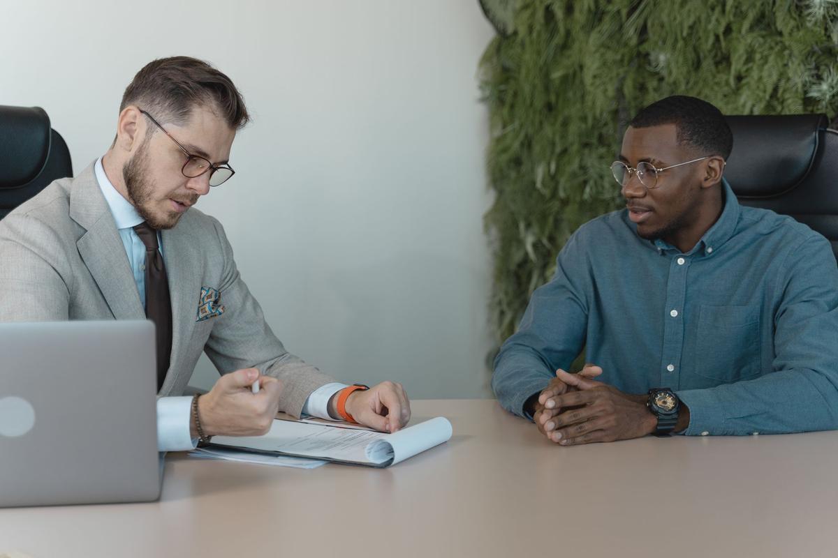 Two men in a job interview seated across from each other in a modern office